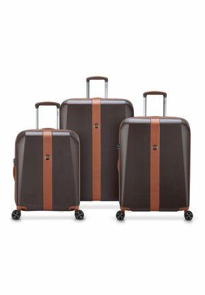 Three hard-shell suitcases in dark brown with light brown accents, featuring retractable handles, zippers, and four wheels each.