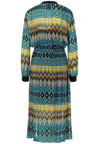 Langärmliges Kleid mit einem mehrfarbigen Zickzackmuster in Blau, Gelb und Schwarz. Elastischer Bund und schwarze Manschettenakzente. Glattes Material.