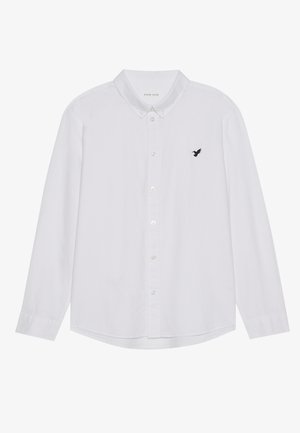 Camicia bianca a maniche lunghe con bottoni in tessuto di cotone. Presenta un logo ricamato di un uccello nero sul lato sinistro del petto e colletto button-down.
