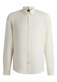 Vaalea beige nappipaita, jossa on levitetty kaulus, pitkät hihat ja suora helma. Kankaan pinta on sileä ja siinä on himmeä kiilto.