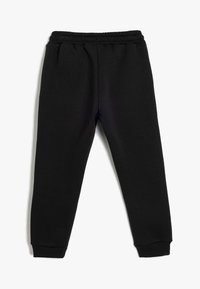 Sorte sweatpants lavet af blødt bomuldsblandingsstof, med en elastisk talje og snævre manchetter for en tætsiddende pasform.