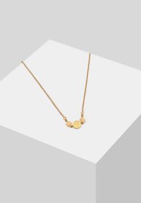 Collana in tono oro con una délicata catena e tre accenti pendenti in metallo texturizzato, tra cui una forma rotonda e forme irregolari.