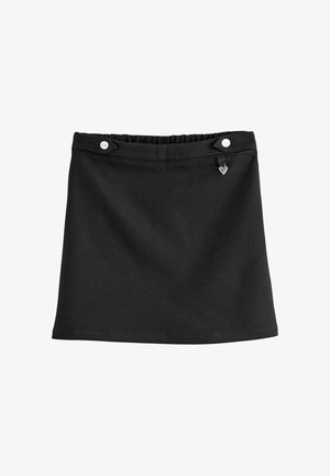 Svart kjol i mjukt tyg med elastisk midja, två vita knappdetaljer och ett litet hjärthänge på ena sidan.