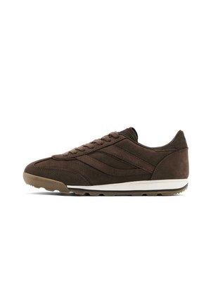 Dark brown suede sneaker with lace-up front, white midsole, and textured brown outsole shown from the side on a white background.