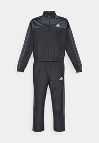 Black athletic tracksuit with a zippered collar. Features grey side stripes and a small white logo on the left chest and right hip.