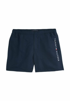 Granatowe szorty kąpielowe wykonane z lekkiego materiału, z elastycznym paskiem w talii i białym logiem "TOMMY HILFIGER" po boku.