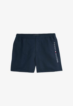Granatowe szorty kąpielowe wykonane z lekkiego materiału, z elastycznym paskiem w talii i białym logiem "TOMMY HILFIGER" po boku.
