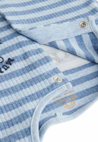 Blue and white striped baby onesie made of soft fabric with snap closures and a round neckline. Features stitching detail and logo tag.