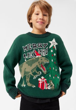 Maglione verde a maglia con un dinosauro, un albero di Natale e regali, con un collo a costine e grafiche festive in rosso, bianco e verde.