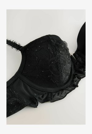 Czarny stanik z koronkowym overlayem z kwiatowym wzorem, cekinami, miękką tkaniną oraz falbankami na taśmie i ramiączkach.
