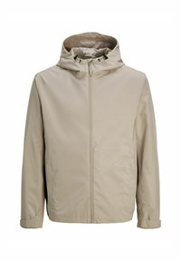 Veste beige à capuche en matériau lisse et léger, avec une fermeture éclair à l'avant et des cordons réglables sur la capuche.