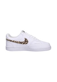 White leather sneakers featuring a leopard print Nike swoosh, round toe, perforated detailing, and textured rubber sole.