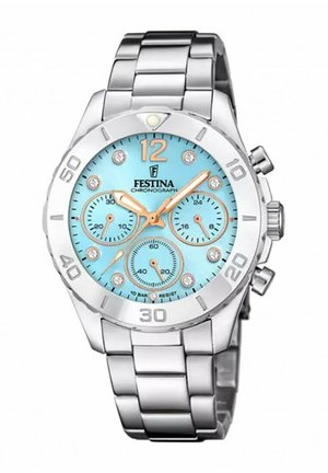 Montre chronographe en acier inoxydable argenté avec un cadran turquoise, trois sous-cadrans, des accents en cristal et des marqueurs d'heure en or.