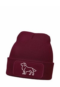 Maroon knitted beanie hat featuring a white outline of a dog on a rectangular patch. The design includes a ribbed texture and a folded cuff.