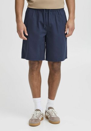 Mørkeblå shorts med elastisk midjebånd og snor, med sidelommer og avslappet passform, laget av lett stoff.