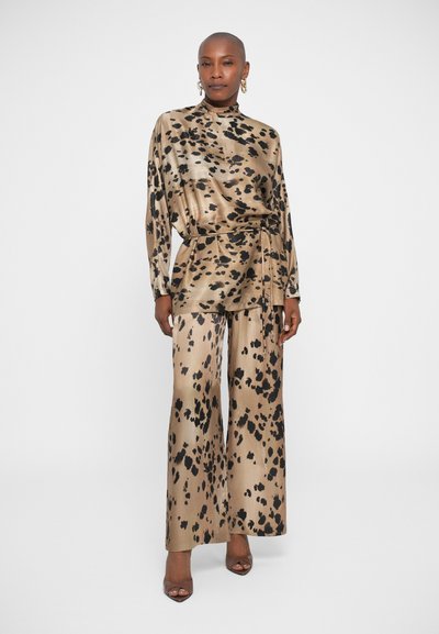 Leopard print satin top and wide-leg pants in beige and black, featuring a high neckline and belt detail. Smooth texture, elegant design.