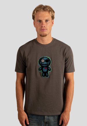 Grå bomulds t-shirt med rund halsudskæring, prydet med en farverig, broderet grafik af en tegneseriefigur i midten.