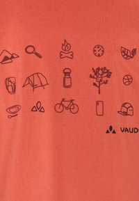 T-shirt rossa con icone nere a tema campeggio, tra cui una tenda, una bicicletta e un fuoco, con il logo "VAUDE" nell'angolo in basso.