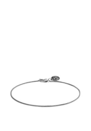 Silver chain bracelet with a fine, woven design. Features a lobster clasp and a circular logo charm attached.