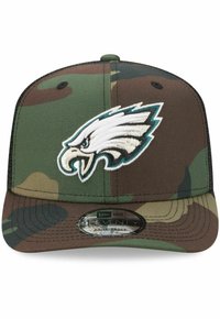 Tarnmuster-Baseballmütze mit einem gestickten Logo eines weißen und türkisfarbenen Adlers, verstellbare Passform und strukturierte Oberfläche.