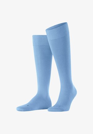 Calcetines hasta la rodilla en un suave color azul, hechos de un material con textura acanalada, con un puño antideslizante y puntera reforzada para mayor durabilidad.
