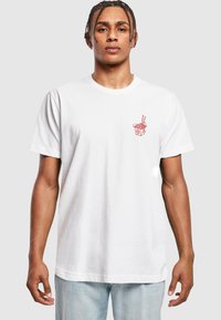 T-shirt en coton blanc avec un graphique rouge d'une boîte à emporter avec des baguettes. Col rond classique et manches courtes. Texture légère et lisse.