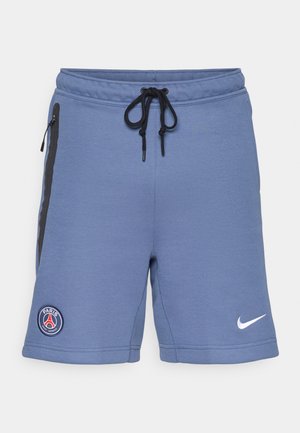 Blue athletic shorts made of soft fabric, featuring black side zippers, a drawstring waist, and a Paris Saint-Germain logo on the left side.