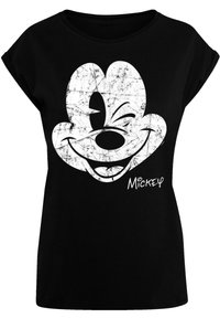 Sort bomulds T-shirt med et slidt hvidt grafik af et smilende Mickey Mouse ansigt, med "Mickey" trykt i en afslappet skrifttype nedenfor.