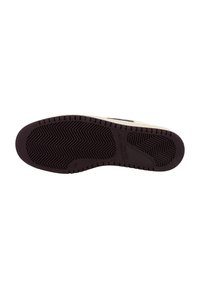 Dark brown rubber shoe sole with a herringbone tread pattern and a cream-colored side. Markings include branding and size details.