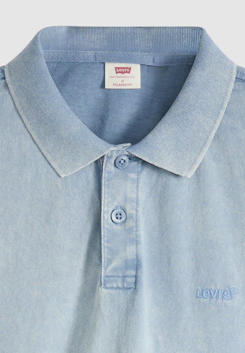 Light blue Levi's polo shirt with two buttons, a collar, and "Levi's" embroidered on the chest in matching blue thread.