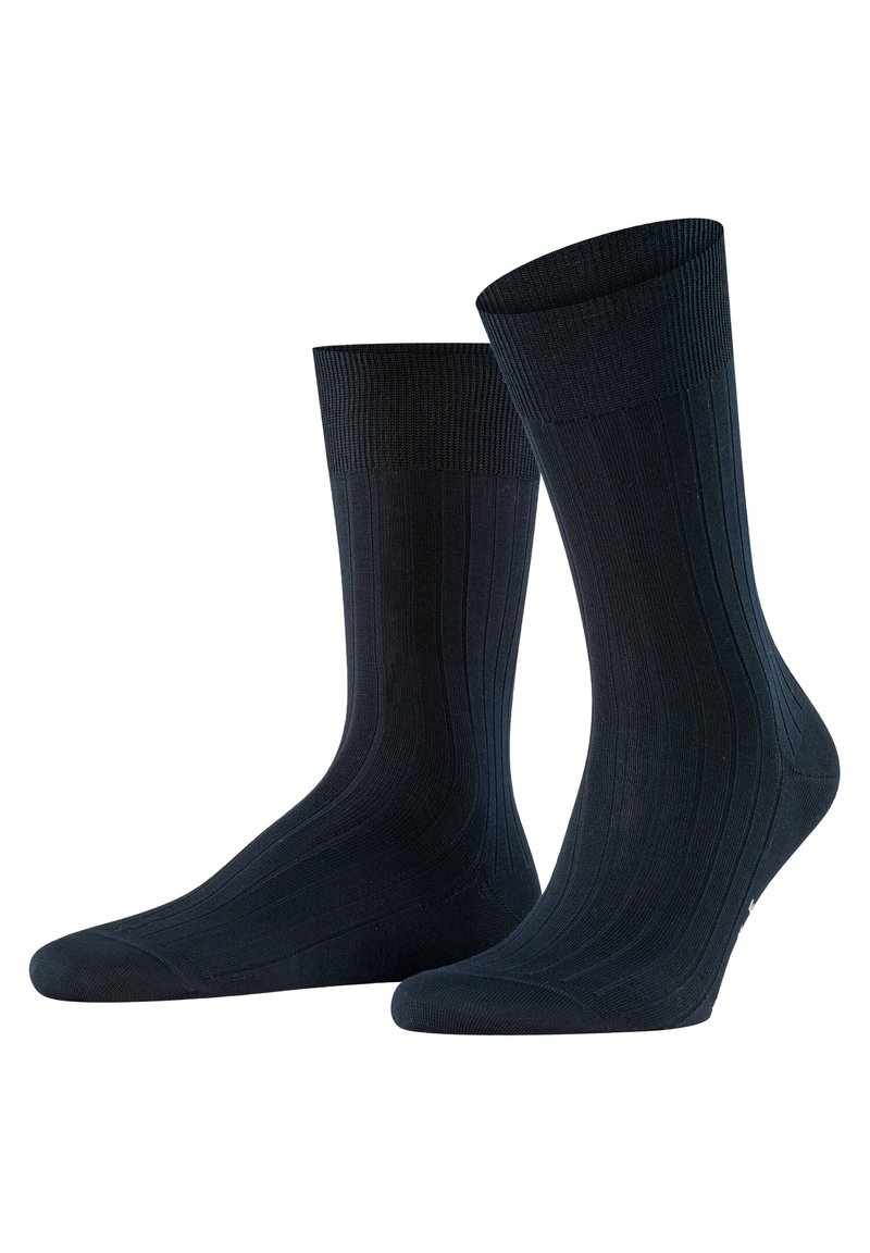 Calcetines de color azul marino con relieve y textura suave, con puntera reforzada, que presentan un puño grueso y un sutil logotipo cerca de la base.