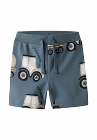 Shorts en coton bleu arborant un motif de tracteur en beige et noir, avec une taille douce et un cordon de serrage pour un ajustement réglable.