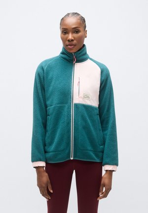 Jachetă din fleece turcoaz cu un panou roz, guler înalt, fermoar complet și două buzunare frontale. Dispune de manșete elastice și o mică insignă cu logo.