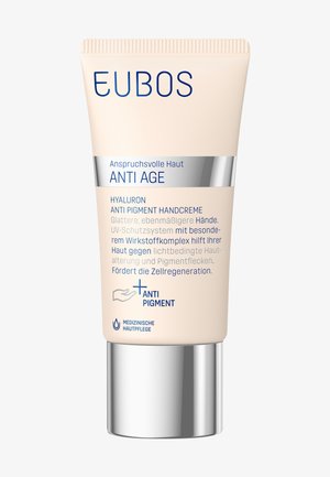 EUBOS Anti Pigment Hand Cream in a soft beige tube. Features a silver base, clear text, and a design focused on anti-aging benefits.