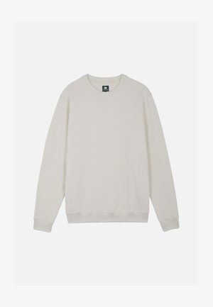 Sudadera de manga larga color crema con puños y bajo acanalados, cuello redondo y una pequeña etiqueta oscura en el cuello.