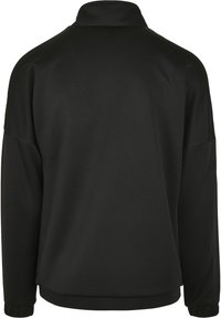 Veste en pull noire en tissu lisse et léger. Dotée d'un col haut et de manches longues avec des poignets élastiques. Design simple, sans motifs.
