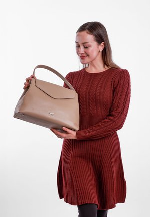 Beige leather handbag with a structured design and a flat closure. Features a single handle and a silver logo detail at the bottom.