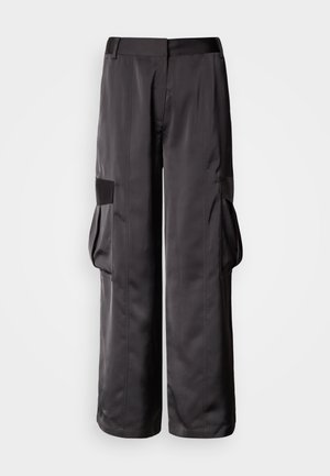 Black cargo pants made of smooth fabric, featuring wide legs, large side pockets, and a flat waistband with accent details.