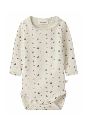 Body bébé crème côtelé à manches longues avec petit motif floral noir, doté de boutons-pression en bas et de bords festonnés.
