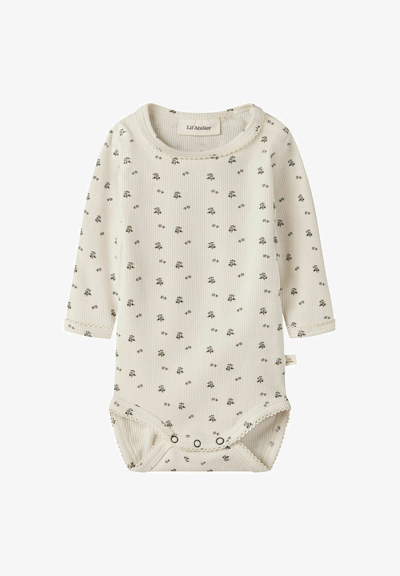 Body bébé crème côtelé à manches longues avec petit motif floral noir, doté de boutons-pression en bas et de bords festonnés.