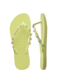 Green rubber flip-flops with textured soles, decorative flower accents, and a strap embellished with small beads and lettering.