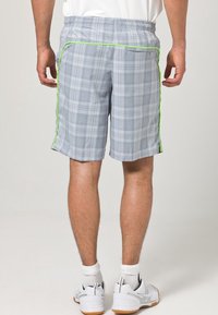Gray plaid shorts made of lightweight fabric, featuring an elastic waistband and green accent piping along the side seam.