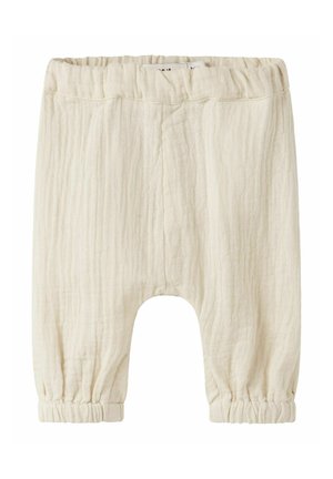 Pantalon doux couleur crème pour bébé avec taille et poignets élastiques, fabriqué en tissu léger texturé.