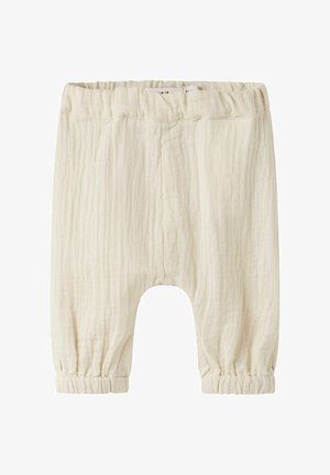 Pantaloni morbidi color crema per bambini con vita e polsini elastici, realizzati in tessuto leggero e strutturato.