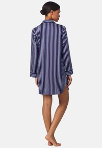 Nachtshirt in marineblau mit langen Ärmeln, Kragen und durchgehender Knopfleiste. Hat vertikale Streifen in Hellrosa und Weiß.