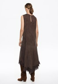 Prune ilmaõlgadega Kleid, millel on kõrge ja madal hem, pitsist ääris allosas ja selja võtmeaugu detail. Valmistatud pehmest, tekstureeritud kangast.
