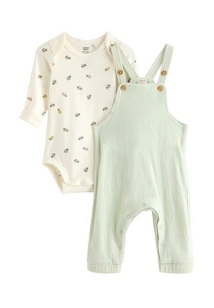Kremfarvet babyheldragt med lange ærmer og flerfarvet mariehøneprint, kombineret med lysegrønne teksturerede bomuldsbukser med træknapper og tryklåse ved benene.