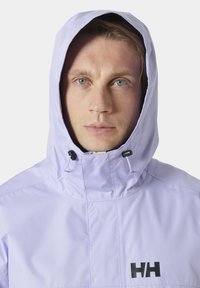 Light purple waterproof jacket with a hood, featuring adjustable drawstrings and a black logo on the chest. Smooth, matte texture.