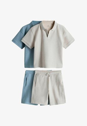 Two ribbed short-sleeve polo shirts and matching drawstring shorts, one set in beige and one in light blue, laid flat on a white background.