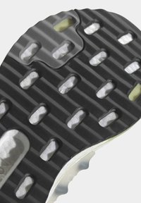 Sort gummisul med rillede mønstre, der har hvide polstringssegmenter og en glat, buet kant for traction og fleksibilitet.